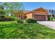Charming home featuring a well-kept lawn, mature landscaping, and a welcoming front entrance at 1294 Kittery St, Castle Rock, CO 80104