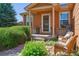 Welcoming front porch with seating, potted plants, and brick accents, adding charm to the home's entrance at 1294 Kittery St, Castle Rock, CO 80104