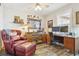 Comfortable home office with a leather chair, desk, and natural light at 1294 Kittery St, Castle Rock, CO 80104
