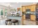 Bright kitchen with light wood cabinets, a granite island, and modern stainless steel appliances at 1294 Kittery St, Castle Rock, CO 80104