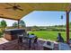 Inviting covered patio featuring a hot tub, dining area, stone flooring, and stunning backyard views at 1294 Kittery St, Castle Rock, CO 80104
