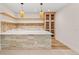 Basement bar area with light brick accent and quartz countertop at 1620 S Ogden St, Denver, CO 80210