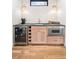 Stylish bar area with wine fridge, microwave, and modern lighting fixtures at 1620 S Ogden St, Denver, CO 80210