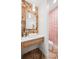 Chic powder room featuring herringbone floors, a modern vessel sink, and stylish wallpaper at 1620 S Ogden St, Denver, CO 80210