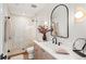 Modern bathroom features a walk-in shower, updated vanity and stylish lighting at 1620 S Ogden St, Denver, CO 80210
