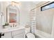 Bright bathroom with modern vanity, white tiled walls, and shower-tub combination at 1620 S Ogden St, Denver, CO 80210