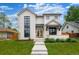 Beautifully designed two-story home with a manicured lawn and modern architectural details at 1620 S Ogden St, Denver, CO 80210