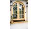 Inviting front door with an arched design, enhanced by stylish lighting fixtures and a welcome mat at 1620 S Ogden St, Denver, CO 80210