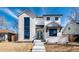Elegant, two-story home features a white brick facade and a striking arched doorway at 1620 S Ogden St, Denver, CO 80210