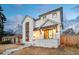 Elegant two-story home with a white brick exterior, manicured lawn, and a welcoming front porch with stylish lighting at 1620 S Ogden St, Denver, CO 80210