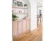 Hallway with hardwood floors, built-in cabinets, and decorative shelving at 1620 S Ogden St, Denver, CO 80210