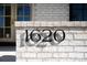 Close-up of the house number '1620' on a white brick wall, showcasing its modern design at 1620 S Ogden St, Denver, CO 80210