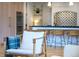 Stylish kitchen view from the living room features bar seating, tile backsplash, and modern appliances at 1620 S Ogden St, Denver, CO 80210