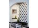 Up-close view of the kitchen's decorative backsplash and high-end stainless steel appliances at 1620 S Ogden St, Denver, CO 80210