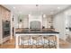Stunning kitchen island with counter seating, a unique backsplash, and pendant lighting at 1620 S Ogden St, Denver, CO 80210