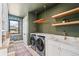 Well-lit laundry room with modern washer and dryer and stylish fixtures at 1620 S Ogden St, Denver, CO 80210