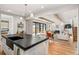 Open floor plan with hardwood floors, modern kitchen island, and bright living room with fireplace at 1620 S Ogden St, Denver, CO 80210