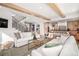 Open-concept living space with a staircase, fireplace, and views into the kitchen at 1620 S Ogden St, Denver, CO 80210