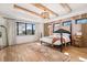 Bright main bedroom with wooden beams, decorative wall and large windows providing ample natural light at 1620 S Ogden St, Denver, CO 80210