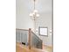 Staircase with wood treads, black metal railing, and contemporary light fixtures at 1620 S Ogden St, Denver, CO 80210