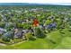 An aerial view of the home in a neighborhood surrounded by lush green trees and a golf course at 8040 W 78Th Cir, Arvada, CO 80005