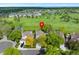 Beautiful aerial view of the property backing onto a golf course with mature trees and lush green landscaping at 8040 W 78Th Cir, Arvada, CO 80005