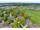 An aerial view of a home surrounded by mature trees in a neighborhood with a golf course at 8040 W 78Th Cir, Arvada, CO 80005