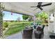 Inviting covered patio with ceiling fan, fire pit, and beautiful views of the golf course and community at 8040 W 78Th Cir, Arvada, CO 80005