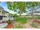 Beautiful backyard featuring a manicured lawn, mature trees, and a view of the golf course at 8040 W 78Th Cir, Arvada, CO 80005