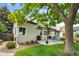 Lush backyard with mature trees, green grass, and a patio perfect for outdoor entertaining at 8040 W 78Th Cir, Arvada, CO 80005