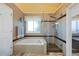 Relaxing bathroom features a deep soaking tub, a glass enclosed shower, and neutral tiling at 8040 W 78Th Cir, Arvada, CO 80005