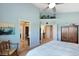 Bright main bedroom featuring vaulted ceilings, decor shelving, and an ensuite bathroom for added privacy at 8040 W 78Th Cir, Arvada, CO 80005