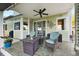 Charming covered patio with comfortable seating and a cozy fireplace, perfect for relaxation at 8040 W 78Th Cir, Arvada, CO 80005
