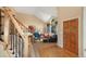 Warm foyer with hardwood floors and a staircase leading to the upper level at 8040 W 78Th Cir, Arvada, CO 80005