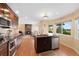 Bright kitchen open to the living room features stainless appliances and a center island with dishwasher at 8040 W 78Th Cir, Arvada, CO 80005