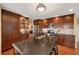 Beautiful kitchen featuring dark cabinets, stainless steel appliances, tile backsplash, and a large center island at 8040 W 78Th Cir, Arvada, CO 80005