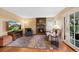 Comfortable living room with a stone fireplace, hardwood floors, and ample seating at 8040 W 78Th Cir, Arvada, CO 80005