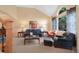 Spacious living room with vaulted ceilings, large windows, and comfortable seating arrangements at 8040 W 78Th Cir, Arvada, CO 80005
