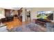 Open floor plan view of a kitchen and living room featuring hardwood floors at 8040 W 78Th Cir, Arvada, CO 80005