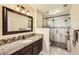 Beautiful bathroom featuring granite countertops, custom tile, and a glass-enclosed shower at 19690 E Mann Creek Dr # A, Parker, CO 80134