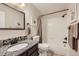 A full bathroom features a granite vanity, a mirror and a tiled bathtub with shower at 19690 E Mann Creek Dr # A, Parker, CO 80134