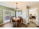 Cozy dining area with wood floors, chandelier, and sliding door to backyard at 19690 E Mann Creek Dr # A, Parker, CO 80134