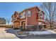 The exterior showcases attached garages, balconies, and well-maintained landscaping and a nearby fountain at 19690 E Mann Creek Dr # A, Parker, CO 80134