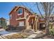 Attractive two-story home boasting a welcoming entrance, painted wood siding, and landscaped front yard at 19690 E Mann Creek Dr # A, Parker, CO 80134