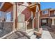 Inviting townhome featuring a brick foundation, and a covered front porch with stairs and railing at 19690 E Mann Creek Dr # A, Parker, CO 80134