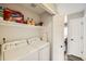 Bright laundry room includes a washer, a dryer, overhead storage and access to another room at 19690 E Mann Creek Dr # A, Parker, CO 80134