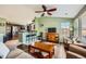 Well-lit living room with a kitchen bar, hardwood floors, and comfortable seating area at 19690 E Mann Creek Dr # A, Parker, CO 80134