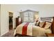 Comfortable bedroom with a large arched window and a walk-in closet at 19690 E Mann Creek Dr # A, Parker, CO 80134