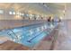 Bright indoor pool featuring lap lanes, large windows, and tiled walls in a well-maintained community space at 19690 E Mann Creek Dr # A, Parker, CO 80134