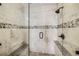 Luxurious glass shower with bench seating, custom tile, and sleek fixtures at 19690 E Mann Creek Dr # A, Parker, CO 80134